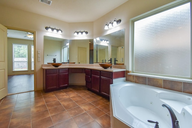2614 Palm Harbour Dr, Missouri City, TX 77459 - full bathroom with a tub with jets, double vanity, ceiling fan, and tile patterned flooring