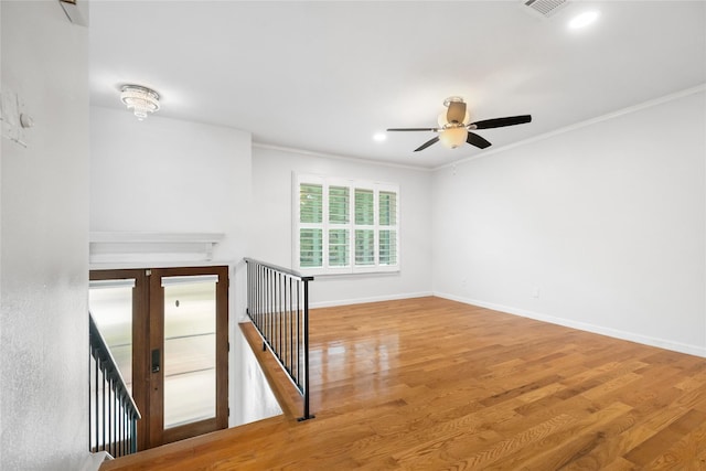 13 Whistlers Ct, The Woodlands, TX 77380 - spare room featuring ceiling fan, wood finished floors, crown molding, recessed lighting, and baseboards