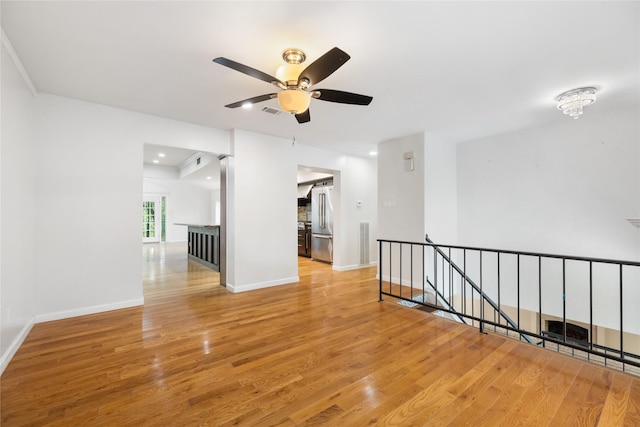 13 Whistlers Ct, The Woodlands, TX 77380 - empty room featuring wood finished floors, ceiling fan, and baseboards