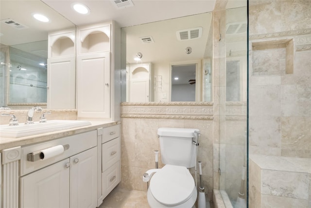 13 Whistlers Ct, The Woodlands, TX 77380 - full bathroom with a shower stall, vanity, toilet, and tile walls