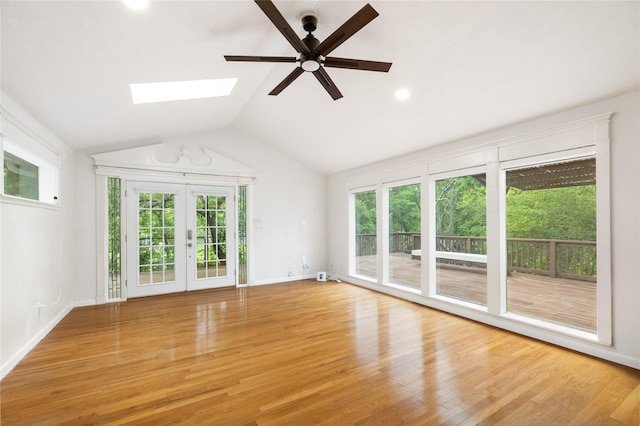 13 Whistlers Ct, The Woodlands, TX 77380 - unfurnished living room with a skylight, plenty of natural light, light wood-style floors, and lofted ceiling