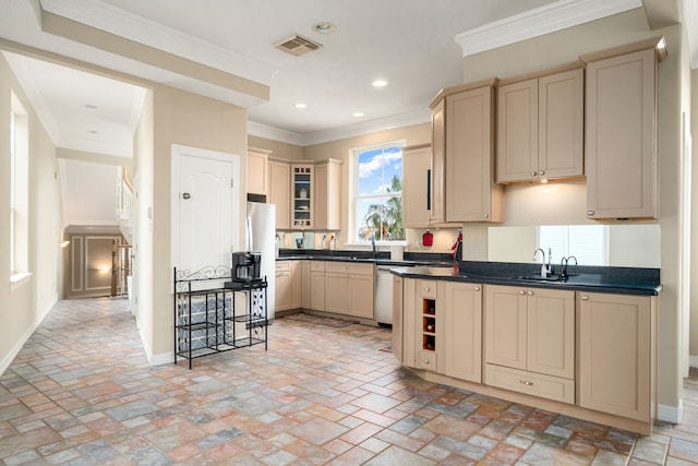 1854 Tiki Dr, Tiki Island, TX 77554 - kitchen with cream cabinetry, a sink, dark countertops, freestanding refrigerator, and recessed lighting
