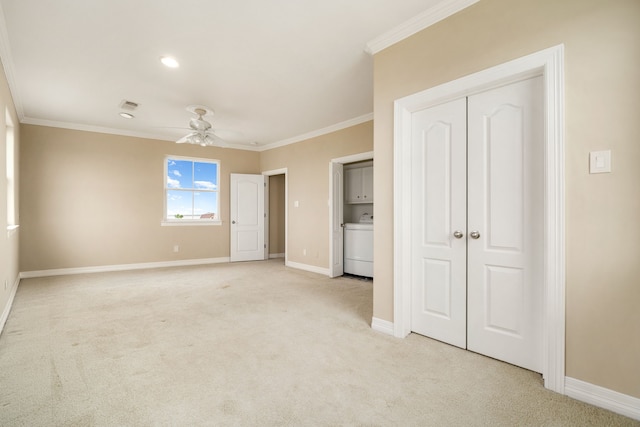 1854 Tiki Dr, Tiki Island, TX 77554 - unfurnished bedroom featuring ornamental molding, washer / dryer, light colored carpet, baseboards, and ceiling fan