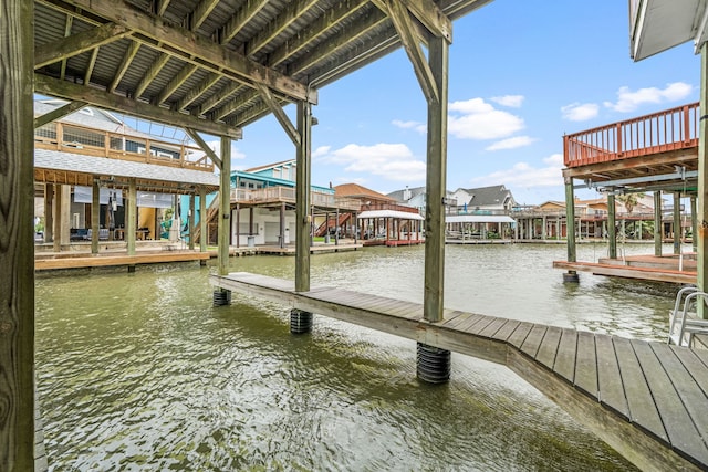1854 Tiki Dr, Tiki Island, TX 77554 - dock with a water view, stairs, and a residential view