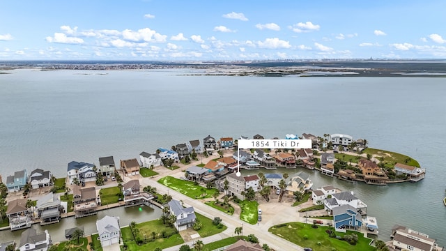 1854 Tiki Dr, Tiki Island, TX 77554 - aerial perspective of suburban area with a nearby body of water