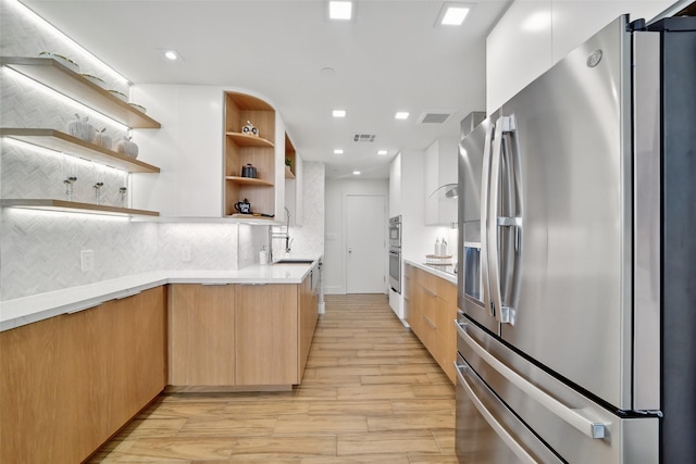 5110 San Felipe St Unit 97W, Houston, TX 77056 - kitchen with appliances with stainless steel finishes, modern cabinets, open shelves, light wood finished floors, and decorative backsplash