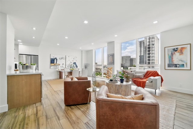 5110 San Felipe St Unit 97W, Houston, TX 77056 - living room with light wood-style floors, baseboards, and recessed lighting
