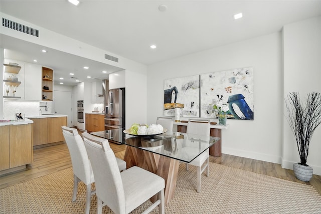 5110 San Felipe St Unit 97W, Houston, TX 77056 - dining space with light wood-style flooring and recessed lighting