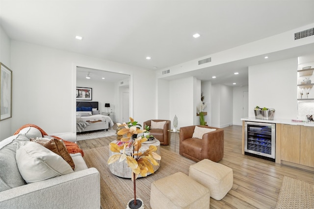5110 San Felipe St Unit 97W, Houston, TX 77056 - living room featuring wine cooler, wet bar, light wood-style floors, recessed lighting, and baseboards