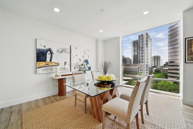 5110 San Felipe St Unit 97W, Houston, TX 77056 - dining area featuring wood finished floors, baseboards, and a view of city