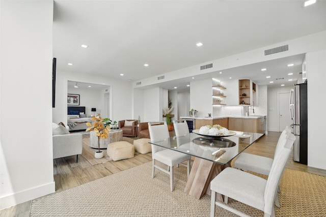 5110 San Felipe St Unit 97W, Houston, TX 77056 - dining space with light wood-style flooring and recessed lighting