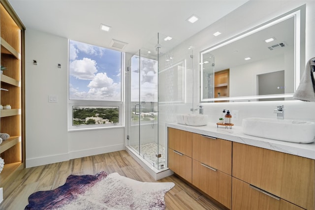 5110 San Felipe St Unit 97W, Houston, TX 77056 - bathroom with double vanity, wood finished floors, and a stall shower