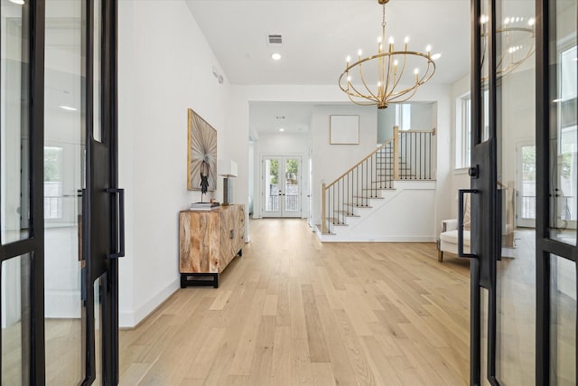 1115 Potomac Dr Unit B, Houston, TX 77057 - foyer entrance featuring french doors, stairs, light wood-style floors, baseboards, and a chandelier