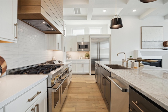1115 Potomac Dr Unit B, Houston, TX 77057 - kitchen featuring built in appliances, a sink, custom exhaust hood, light wood finished floors, and recessed lighting