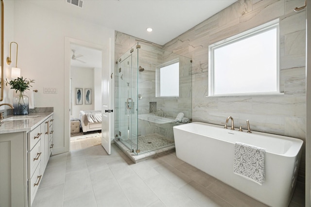 1115 Potomac Dr Unit B, Houston, TX 77057 - bathroom featuring vanity, a soaking tub, a shower stall, ensuite bathroom, and tile patterned floors
