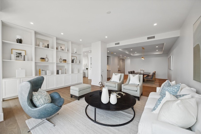 5656 San Felipe St Unit 1301, Houston, TX 77056 - living area featuring light wood-style flooring, recessed lighting, a tray ceiling, and baseboards