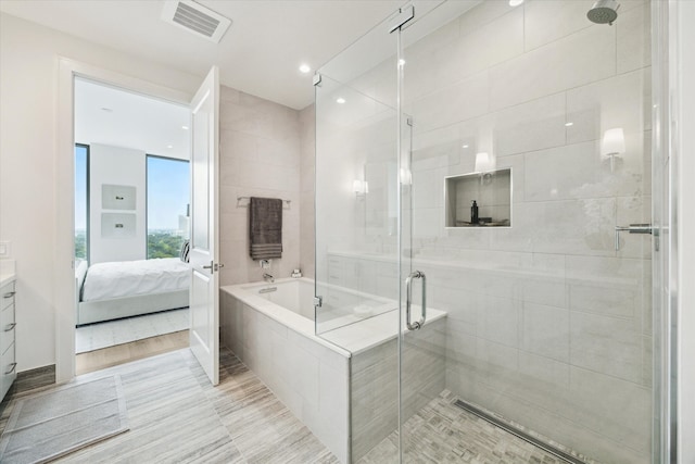 5656 San Felipe St Unit 1301, Houston, TX 77056 - bathroom with a shower stall, ensuite bath, vanity, a bath, and recessed lighting