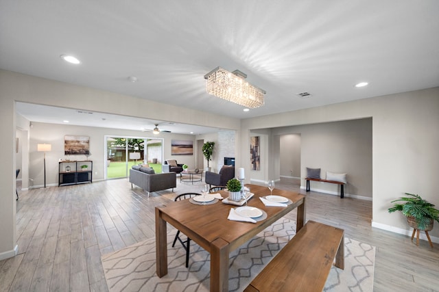 4003 Mischire Dr, Houston, TX 77025 - dining area featuring light wood-style floors, baseboards, recessed lighting, a ceiling fan, and a chandelier