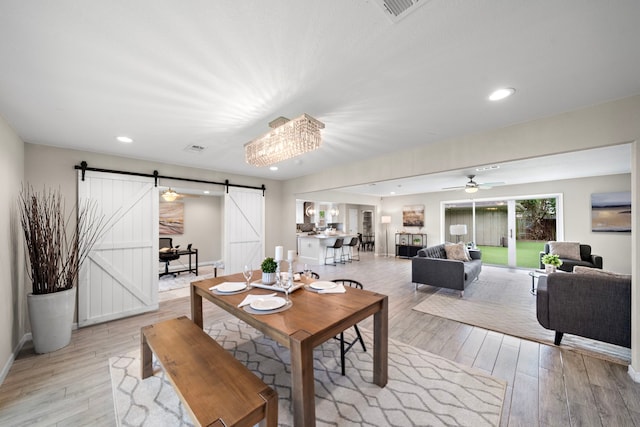 4003 Mischire Dr, Houston, TX 77025 - dining area with a barn door, light wood finished floors, ceiling fan, recessed lighting, and baseboards