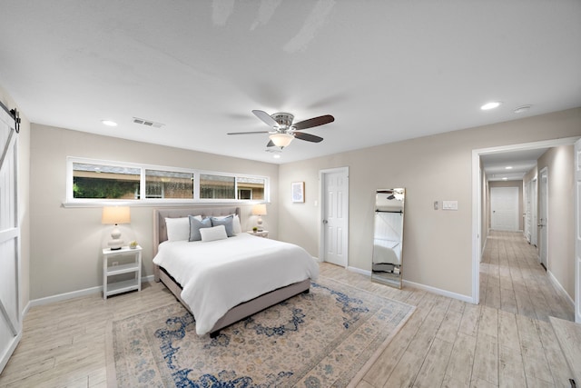 4003 Mischire Dr, Houston, TX 77025 - bedroom featuring a barn door, light wood-style flooring, a ceiling fan, baseboards, and recessed lighting