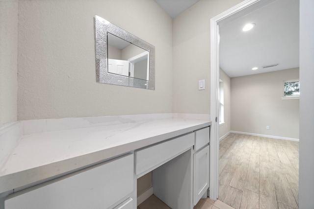 4003 Mischire Dr, Houston, TX 77025 - hall featuring plenty of natural light, light wood-style floors, a desk, recessed lighting, and baseboards