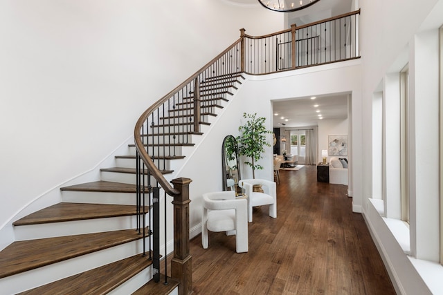 74 N Curly Willow Cir, Tomball, TX 77375 - stairway featuring wood-type flooring, a high ceiling, and baseboards