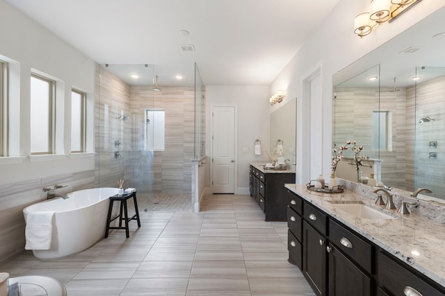 74 N Curly Willow Cir, Tomball, TX 77375 - full bathroom featuring a shower stall, vanity, a freestanding bath, and tile patterned flooring