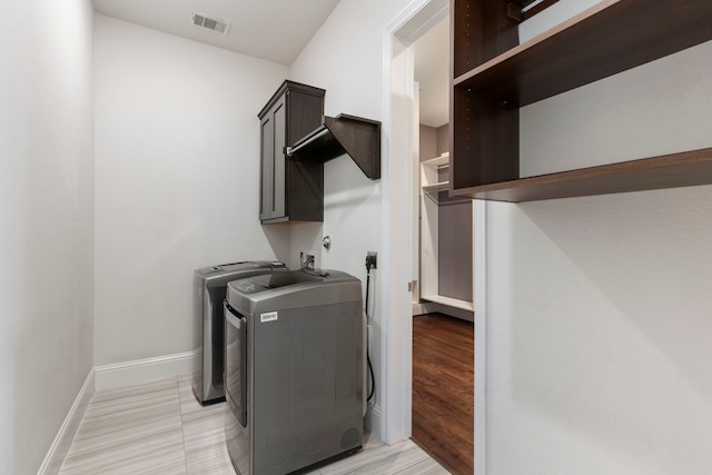 74 N Curly Willow Cir, Tomball, TX 77375 - laundry area with cabinet space, washer and clothes dryer, and baseboards