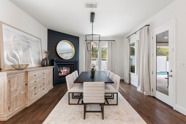 74 N Curly Willow Cir, Tomball, TX 77375 - dining space featuring a large fireplace, dark wood-style flooring, and baseboards
