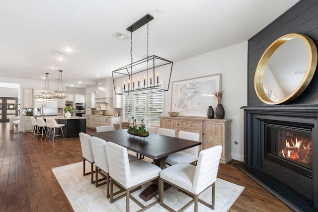 74 N Curly Willow Cir, Tomball, TX 77375 - dining area featuring dark wood-type flooring, a glass covered fireplace, and recessed lighting
