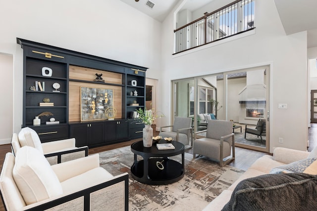 74 N Curly Willow Cir, Tomball, TX 77375 - living room featuring wood finished floors and a towering ceiling