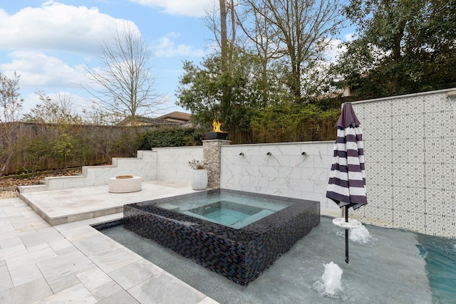 74 N Curly Willow Cir, Tomball, TX 77375 - view of patio / terrace with an in-ground hot tub