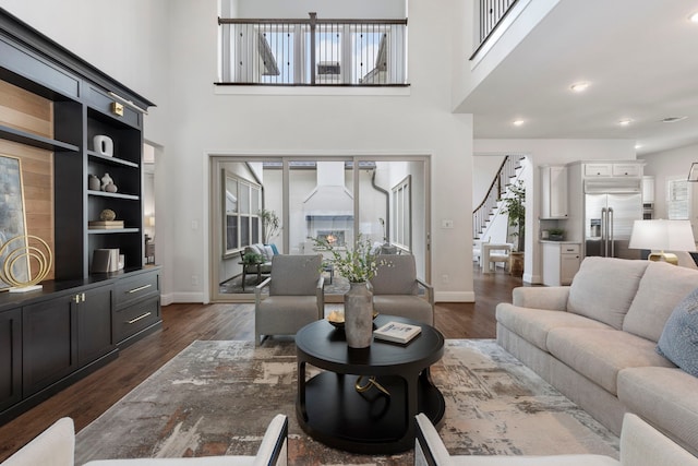 74 N Curly Willow Cir, Tomball, TX 77375 - living room featuring stairs, a towering ceiling, dark wood finished floors, healthy amount of natural light, and baseboards