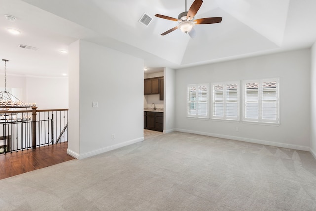 74 N Curly Willow Cir, Tomball, TX 77375 - unfurnished living room featuring light carpet, a ceiling fan, baseboards, a sink, and vaulted ceiling