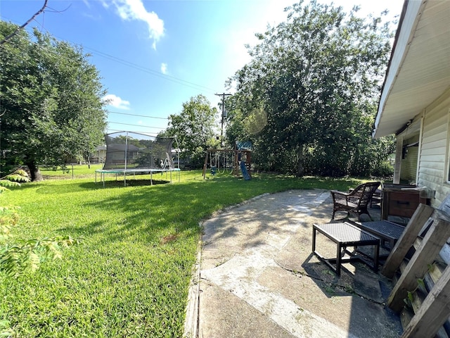 3508 Meadowlane St, Victoria, TX 77901 - view of green lawn featuring a trampoline, a patio area, and a playground