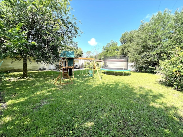 3508 Meadowlane St, Victoria, TX 77901 - view of grassy yard featuring a trampoline and a playground