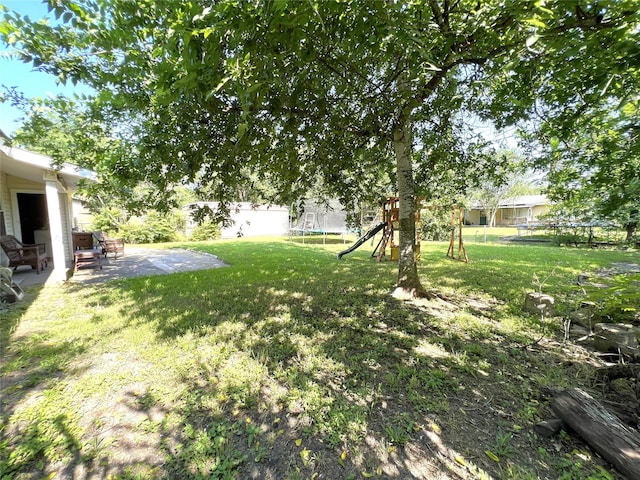 3508 Meadowlane St, Victoria, TX 77901 - view of yard featuring a trampoline, a patio area, and a playground
