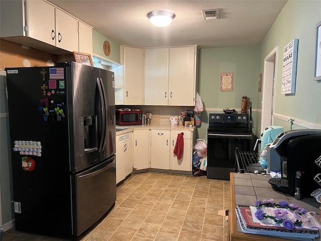 3508 Meadowlane St, Victoria, TX 77901 - kitchen featuring refrigerator with ice dispenser, black range with electric cooktop, light countertops, white cabinets, and a textured ceiling
