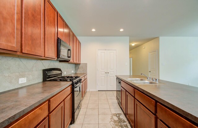 3102 Gianna Springs Ct, Humble, TX 77396 - kitchen with black appliances, a sink, dark countertops, tasteful backsplash, and light tile patterned flooring