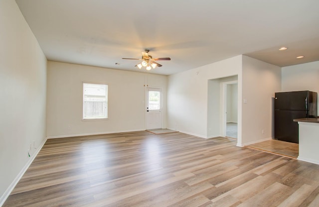 3102 Gianna Springs Ct, Humble, TX 77396 - unfurnished living room with a ceiling fan, light wood-style flooring, baseboards, and recessed lighting