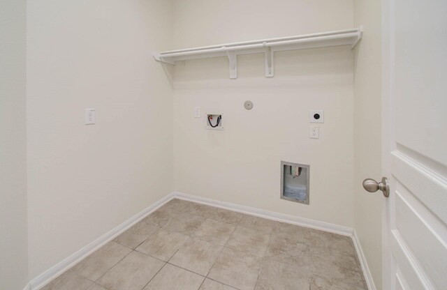 3102 Gianna Springs Ct, Humble, TX 77396 - laundry room with electric dryer hookup, hookup for a gas dryer, light tile patterned floors, baseboards, and hookup for a washing machine