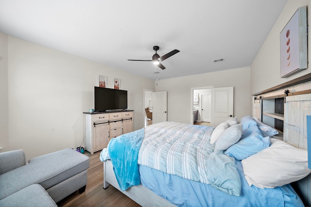 14122 Freeboard Dr, Santa Fe, TX 77510 - bedroom with wood finished floors, a barn door, and ceiling fan