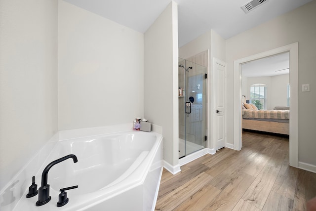 14122 Freeboard Dr, Santa Fe, TX 77510 - ensuite bathroom with a bath, a shower stall, and wood finished floors