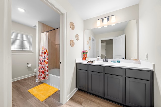 14122 Freeboard Dr, Santa Fe, TX 77510 - full bathroom with vanity, shower / bath combination with curtain, toilet, wood finished floors, and baseboards