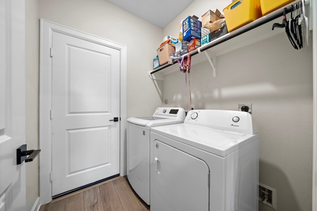 14122 Freeboard Dr, Santa Fe, TX 77510 - washroom with separate washer and dryer and light wood-style flooring