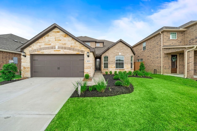 14122 Freeboard Dr, Santa Fe, TX 77510 - french provincial home featuring a front yard, brick siding, a garage, driveway, and stone siding
