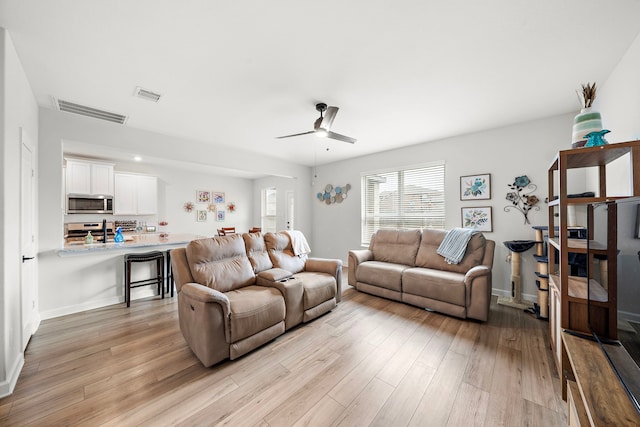 14122 Freeboard Dr, Santa Fe, TX 77510 - living area featuring ceiling fan and light wood finished floors