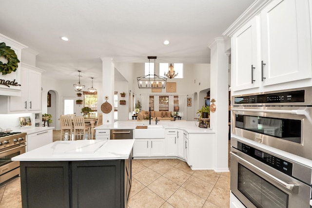 19910 Standing Cypress Dr, Spring, TX 77379 - kitchen featuring stainless steel appliances, white cabinets, a sink, light tile patterned floors, and recessed lighting