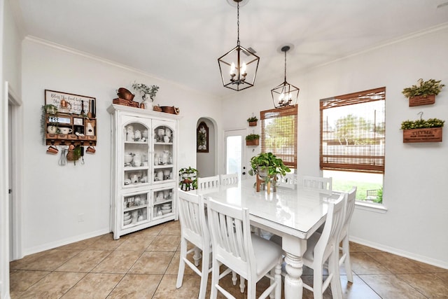 19910 Standing Cypress Dr, Spring, TX 77379 - dining space with a chandelier, light tile patterned flooring, crown molding, arched walkways, and baseboards