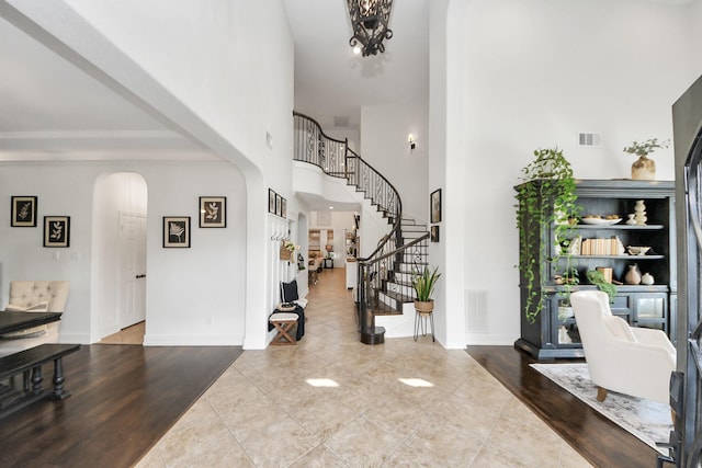 19910 Standing Cypress Dr, Spring, TX 77379 - foyer entrance featuring arched walkways, stairs, a towering ceiling, and baseboards